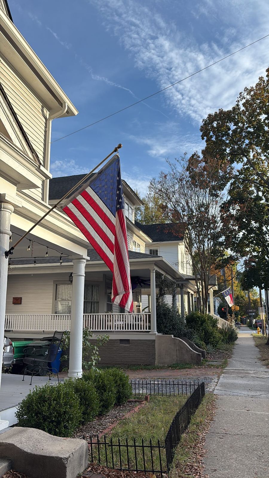 American flag flying from a front porch